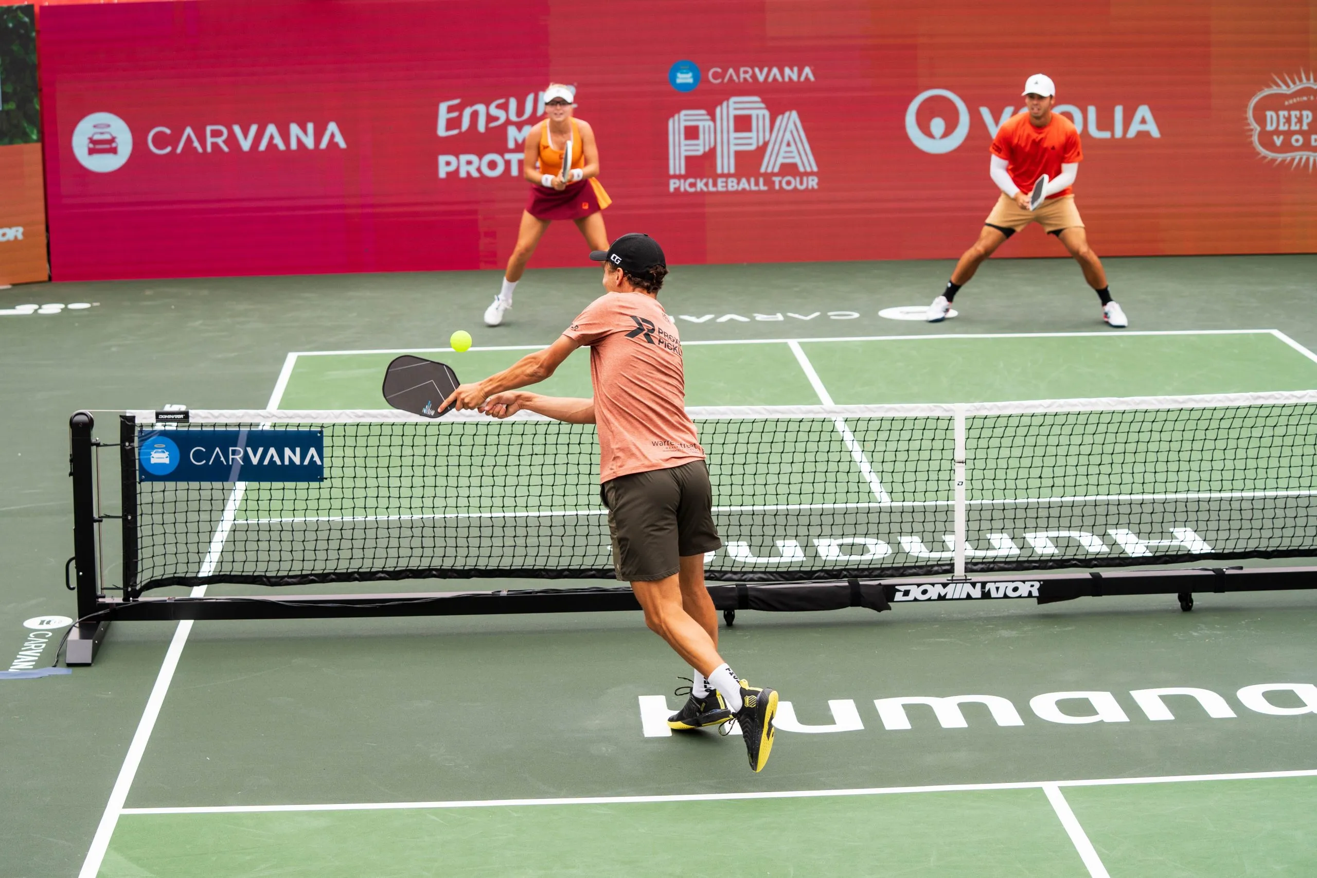 A professional pickleball doubles point framed across the kitchen line